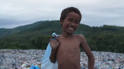 Poor Boy Smiling With Garbage Dump 스톡 동영상 153716769