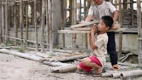 Poor children at the construction site were forced to work. Concept against.. Stock Footage 336942474