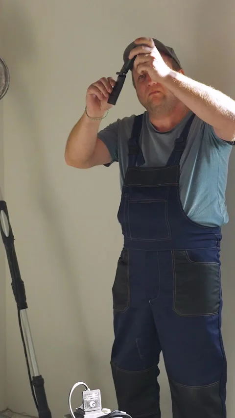 A poor construction worker. Low income for construction workers. A plasterer at Stock-Footage 324047939