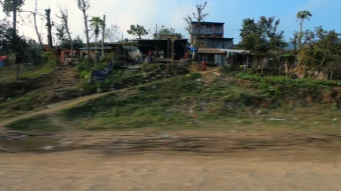 Poor development village with old humber house, green plants and paddy fields Stock Footage 127706160