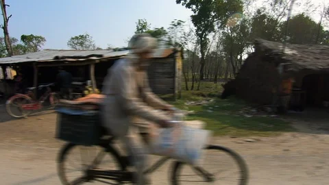 Poor development village with old humber house, green plants and paddy fields  Video stock 127723185