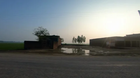 Poor development village with old humber house, green plants and paddy fields Video stock 127729110