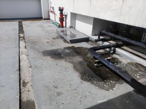 Poor drainage design and construction. water puddle on building roof due to t Stock Photos