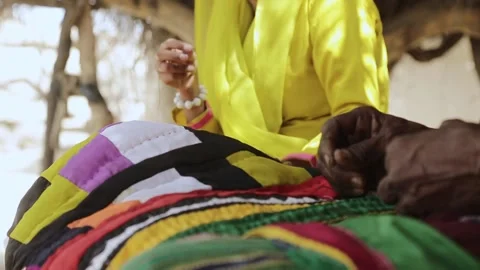 Poor dwarf / tiny woman sewing traditional quilt of Sindh called rilli / ralli i Stock Footage 132188702