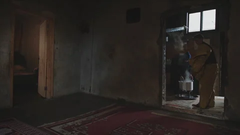 Poor family cooking inside a rustic dark home Stock Footage 330564583