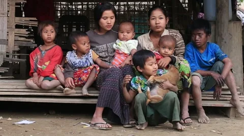 Poor family sits on the street. Poverty is a major issue in Burma, Myanmar Stock Footage