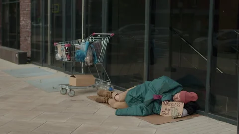 Poor Homeless Man Sleeping on Ground next to Office Building Vídeos de archivo 247256190