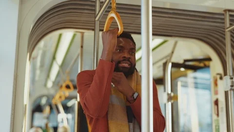 Poor ill bearded young man sneezing allergy while driving in tram. Unwell Stock Footage 121475201