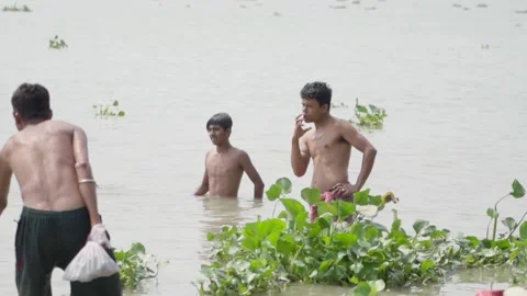Poor Indian people bathing in river bank... | Stock Video | Pond5