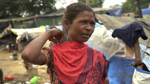 A Poor Indian woman with plastic hut background, Palghar, IndiaStock Footage