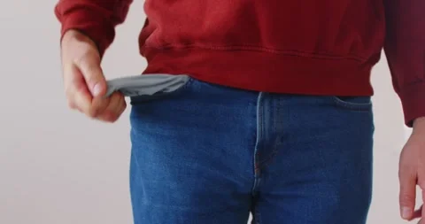 Poor man in casual clothes is frustratedly pulling out his trouser pocket Stock Footage 311273991