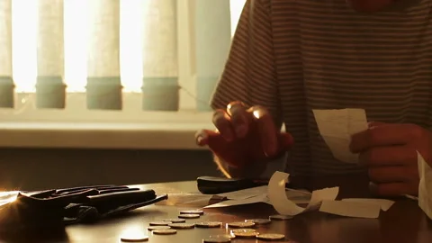 Poor man counting expenses and showing an empty wallet Stock Footage 91725306