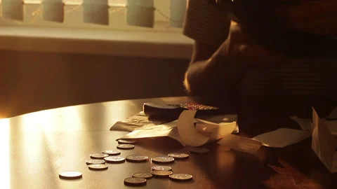 Poor man counting expenses and showing an empty wallet Stock Footage 98137185