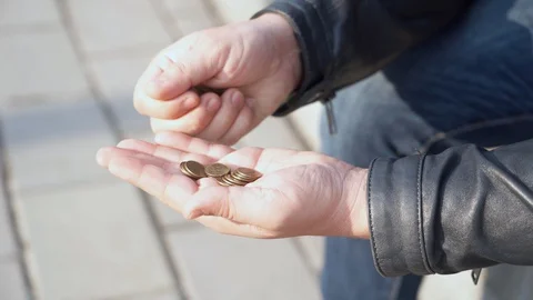 The poor man counts the coins Stock Footage 127827358