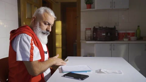 The poor man does financial calculations by looking at bills and has little mone Stock-Footage 220635963