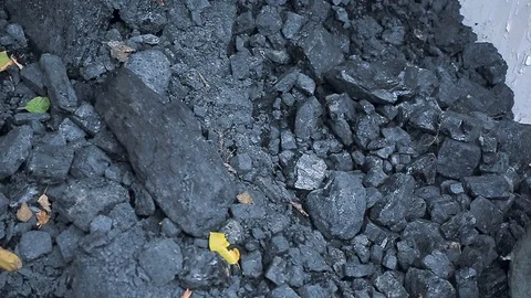A poor man loads natural coal in a truck with a shovel Stock Footage 81798227