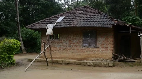 Poor man putting solar panel on his roof Stock Footage 60222780