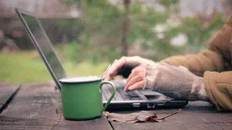 Poor man using laptop and drinking coffee outdoors Video stock 58216292