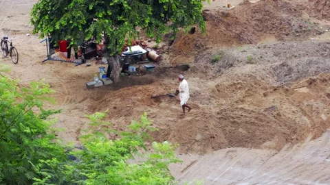 Poor man working in mud Stock Footage 218645715