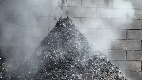Poor quality bio-waste falls into a pile before the final recycling. Waste dump. Stock Footage 232780580
