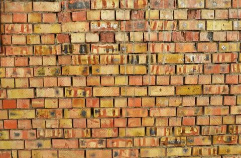 Poor quality brickwork from low quality damaged bricks Stock Photos