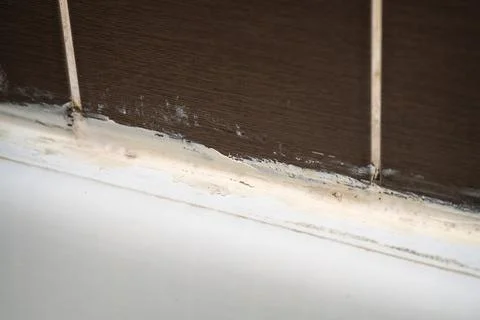 Poor quality waterproofing at the junction between bathtub and ceramic tile.. Stock Photos