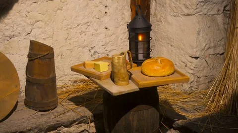 Poor room in a stone house with tools, a candle and food Stock Footage 85243169