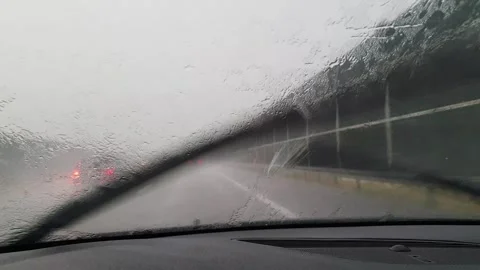 Poor visibility while driving a car during heavy rain. Video stock 246912096