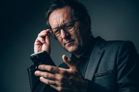 Poor vision or eyesight problem concept. Mature businessman with eyeglasses.. Stock Photos