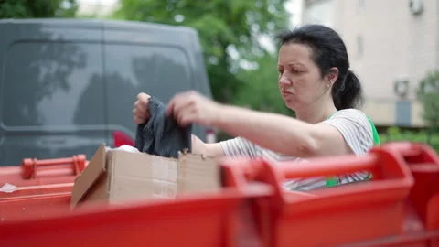 Poor woman digging through trash cans, waste container. Economic poverty problem Video stock 277533281