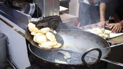 Poori deep frying in oil at old delhi 4k footage Stock Footage 332557553