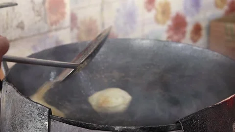 Poori or puri or luchi being fried in hot steaming oil.traditional indian bre Stock-Footage 221742026