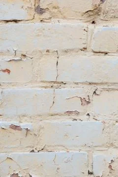 Poorly painted wall of damaged red brick with white paint, textu Stock Photos