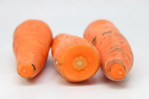 Poorly washed carrots on a light background, carrots deteriorate. Stock Photos