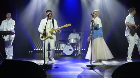 Pop band performing energetically on stage Stock Footage 292008184