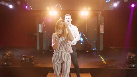 Pop band with two singer and musicians performing in a dark club's stage. Smooth Stock Footage 221016522