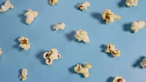Pop corn on a blue background with a hard shadow rotates Video stock 227359279