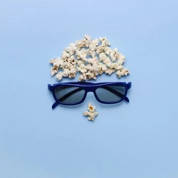 Pop Corn face, 3D glasses on blue background. Watch Movie free time Stock Photos
