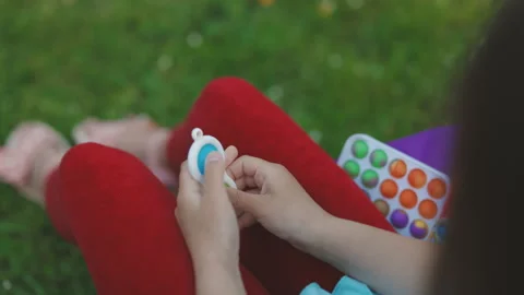 Pop it simple dimple popit anti-stress sensory toy for children. Girl hands Stock Footage 194747340