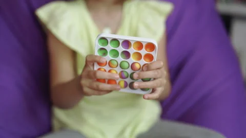 Pop it simple dimple popit anti-stress sensory toy for children. Girl hands Stock Footage 194747593
