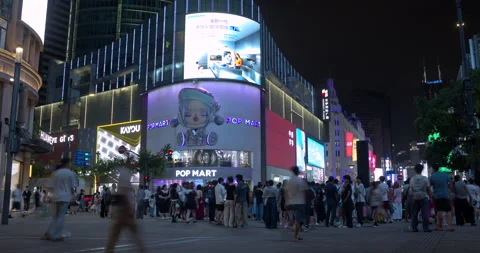 Pop Mart store and changing LED billboard at night in SHANGHAI CHINA Stock Footage 344971234