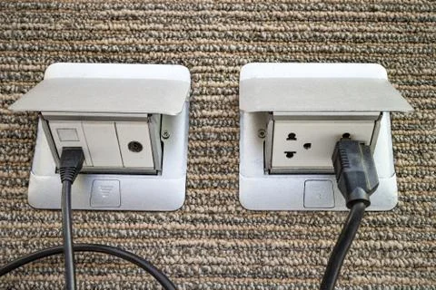 Pop up outlet socket on carpet floor Stock Photos