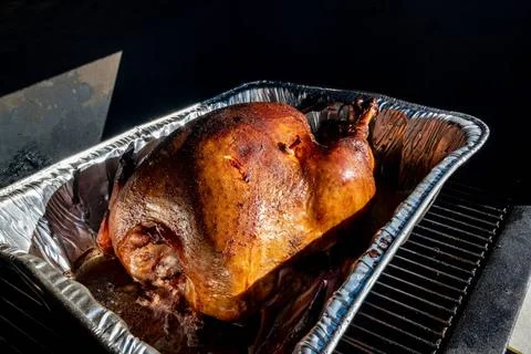 Pop-up thermometer timer in a smoked turkey Turkey in a pan sitting in a s... Stock Photos