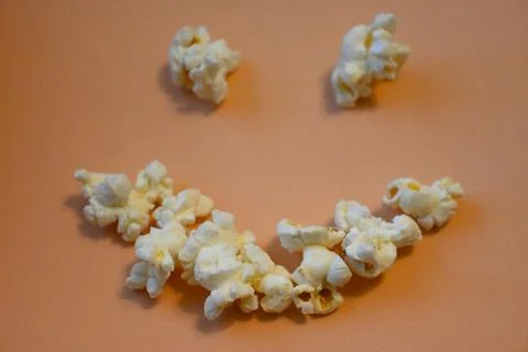 Popcorn arc on an orange background Stock Photos