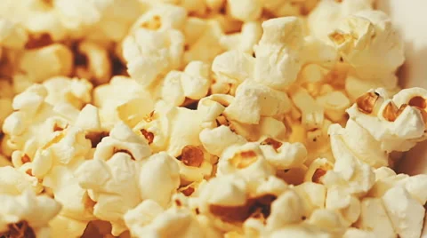 Popcorn background. Close-up panning view of the surface of a large bucket fu Stock-Footage 65114238