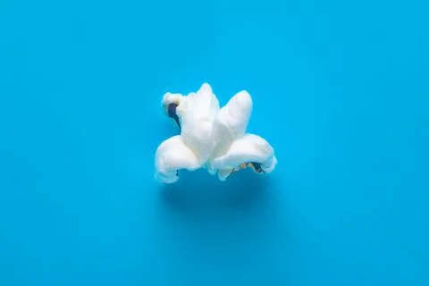 Popcorn on a blue background. Macro image of popcorn Stock Photos