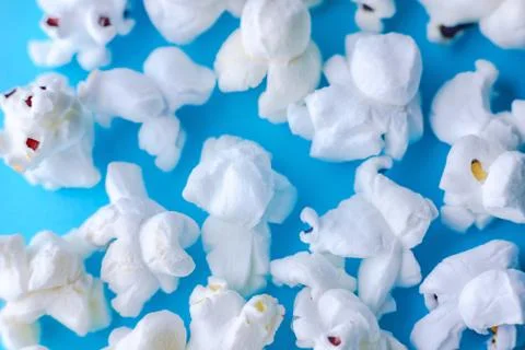 Popcorn on a blue background. Macro image of popcorn Stock Photos