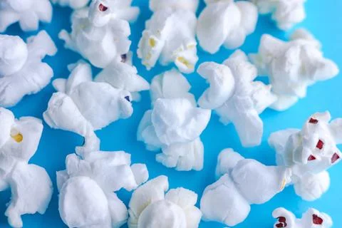 Popcorn on a blue background. Macro image of popcorn Stock Photos