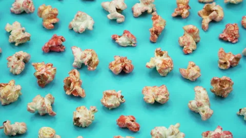 Popcorn on Blue background. Top view and close up rotation. Stock Footage 87054541