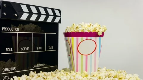 Popcorn box with clapper board rotate on white background Видео 76385805